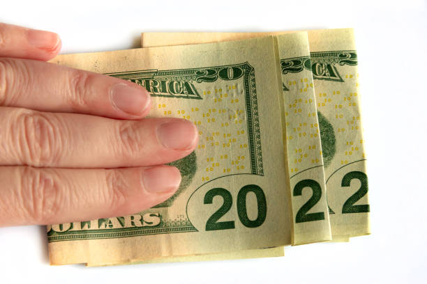 istock 2022 written with dollars bank notes in a hand isolated on white background, new year greetings money concept 1346148682
