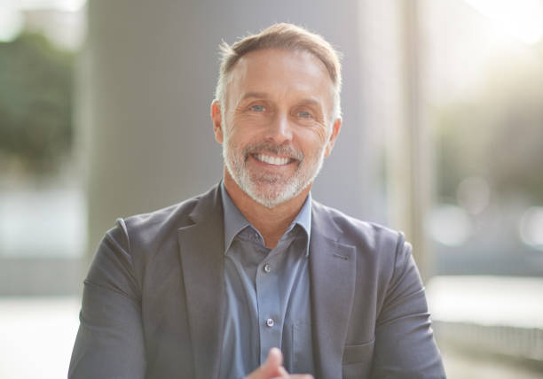 shot of a businessman sitting at his favourite coffee shop in the morning - old human face men ceo imagens e fotografias de stock