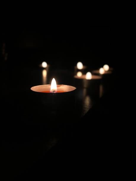 istock Beautiful burning candles. In a dark room 1346149986