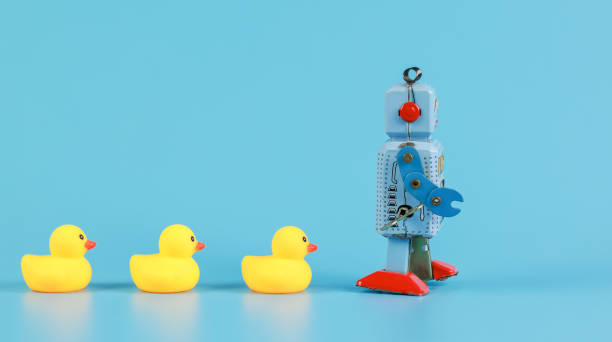 vintage retro robot and Yellow Rubber Bath Ducks, leadership concept