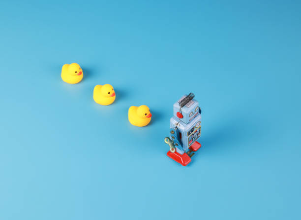 istock vintage retro robot and Yellow Rubber Bath Ducks, leadership concept 1346151106
