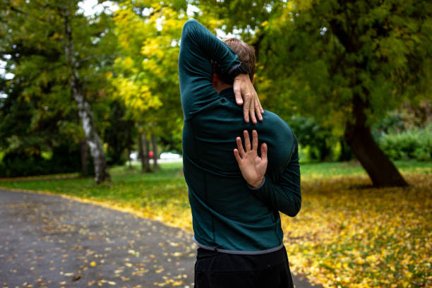 istock Young man stretching before running in city park 1346151334