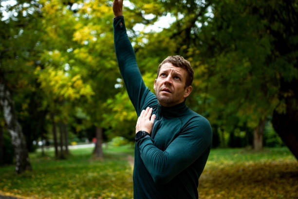 istock Young man stretching before running in city park 1346151341