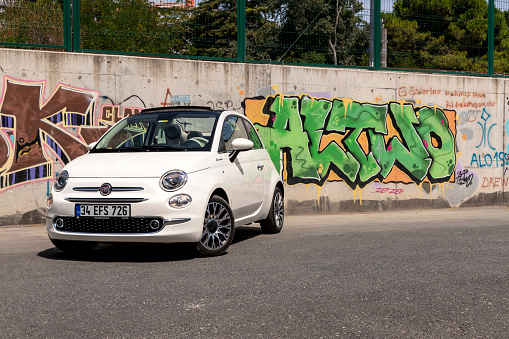 Enschede, Twente, Overijssel, Netherlands, april 5th 2022, daytime close-up of a Dutch black 2016 Abarth 500 on the 'Hengelosestraat' city street in Enschede on a rainy day - the Abarth 500 model is an exclusive tuned version of the Fiat 500 made by Italian, Turin based car manufacturer Abarth & C. S.p.A. since 2008