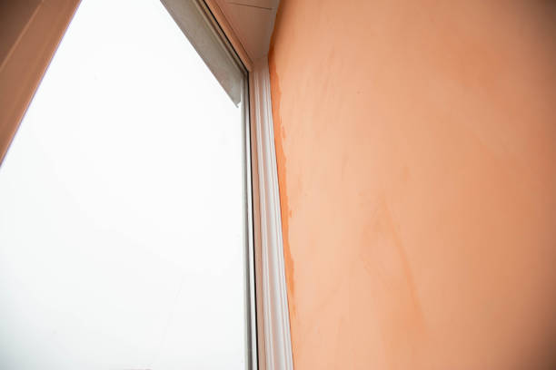 istock Rain dripping in the corner on the balcony between the window frame and the wall. Damage to walls due to poor quality repairs. Copy space for text 1346152871