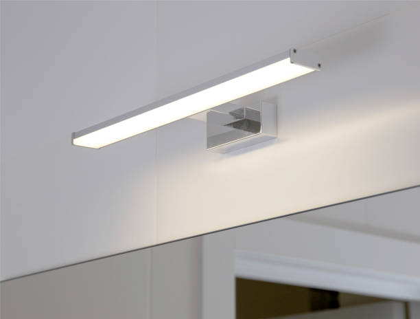 istock Stylish LED wall light above the bathroom mirror. Modern lighting, close-up 1346153193