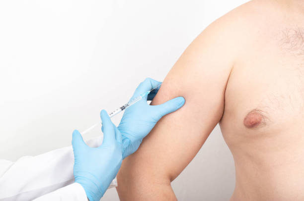 istock A plastic surgeon doctor makes an injection into a man's arm for skin elasticity. Copy space for text 1346154414