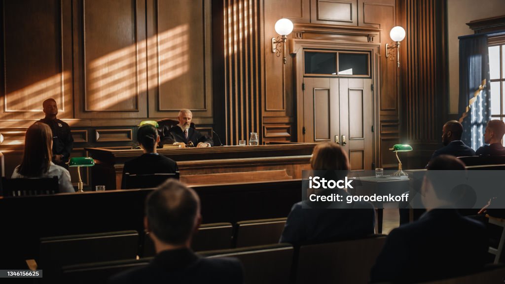 Court of Justice Trial: Impartial Judge is Sitting, Public Stands. Supreme Federal Court Judge Starts Civil Case Hearing. Sentencing Law Offender. Courtroom Stock Photo