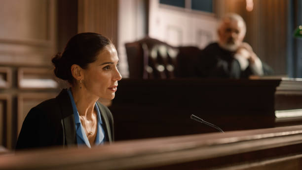 court of law and justice: portrait of beautiful female victim giving heartfelt testimony to judge, jury. emotional speech of empowered woman against crime, injustice, prejudice, corruption - domestic issues imagens e fotografias de stock