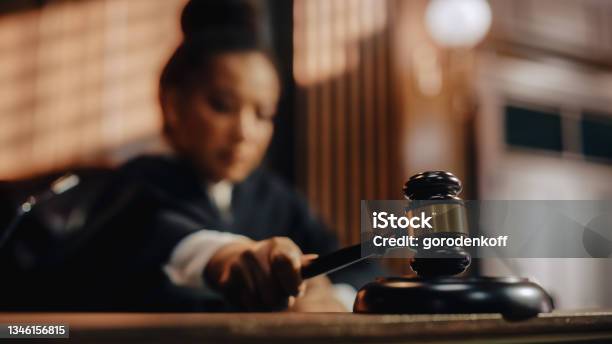 Court Of Law Trial In Session Honorable Female Judge Pronouncing Sentence Striking Gavel Focus On Mallet Hammer Cinematic Shot Of Dramatic Not Guilty Verdict Closeup Shot Stock Photo - Download Image Now