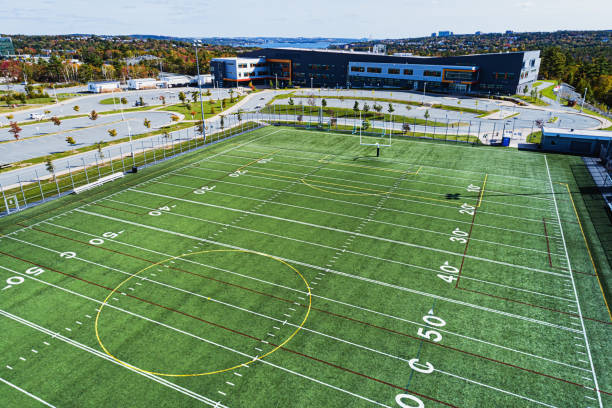 Football Field Aerial view of a dual purpose American/European football field at a public high school. high school soccer stock pictures, royalty-free photos & images
