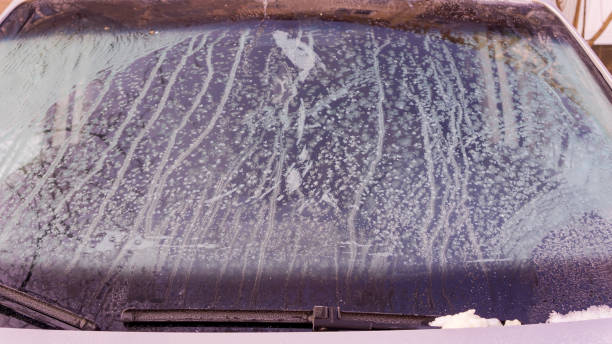 istock Winter frozen front window car, ice glass freeze texture background 1346162019