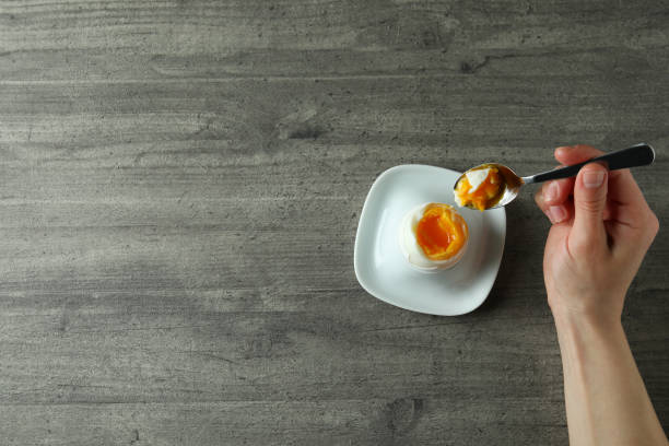 istock Concept of tasty breakfast with boiled egg on gray textured background 1346163640