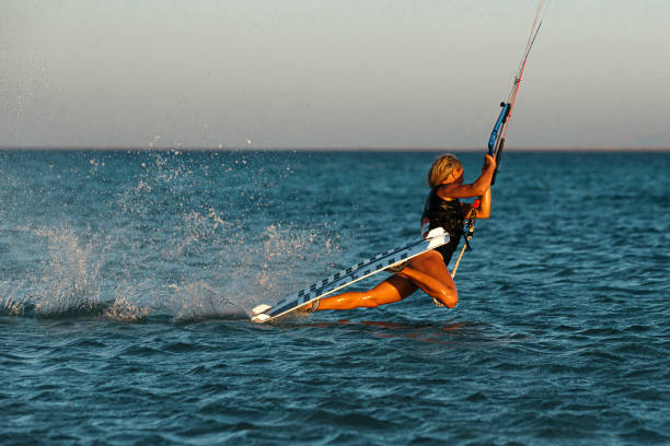 istock Kite surfer woman rides with kiteboard  in transition 1346163980