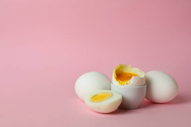 istock Tasty boiled eggs on pink background, space for text 1346164227