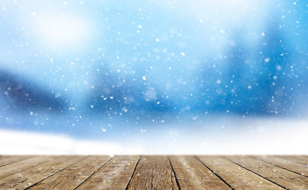 istock Wooden planks against a blurred background in winter 1346167556