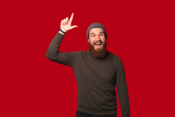 istock Handsome bearded man is pointing up or making I have an idea gesture. 1346167926
