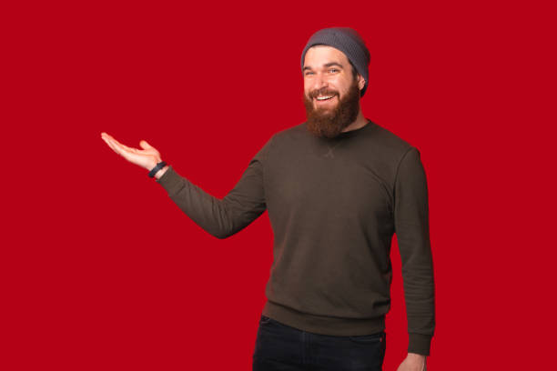 istock Smiling man is holding hand like he is presenting or holding something. 1346167930