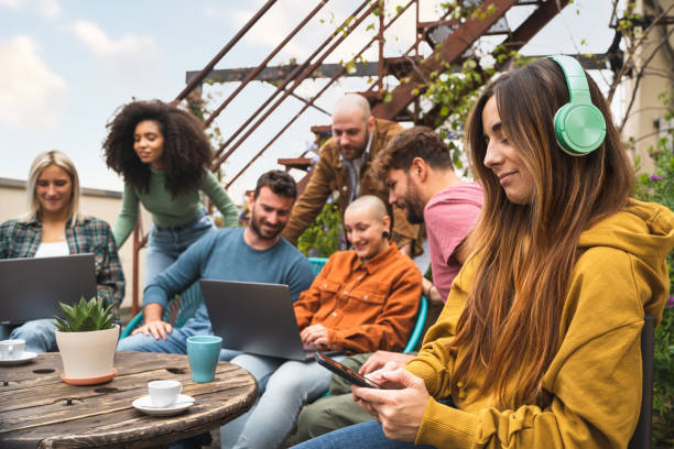 istock Multiracial group of students working together using digital devices such as laptops and smartphones in the campus terrace, co-working outdoors together 1346168843