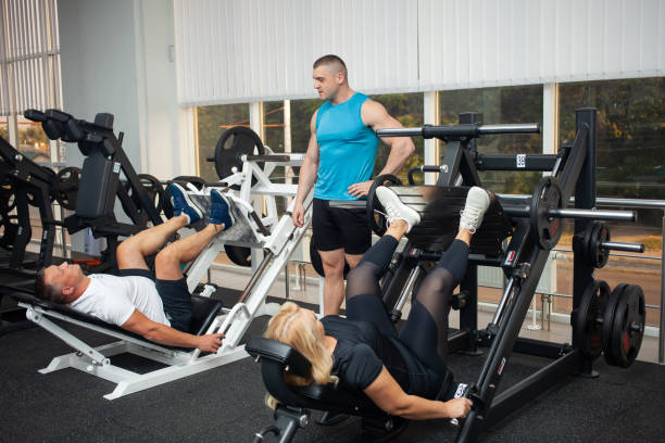 istock A young coach teaches and shows a person correct technique of performing an exercise on a simulator. Healthy lifestyle, weight loss. fat clients, body positivity, model size plus. man and woman 1346170232
