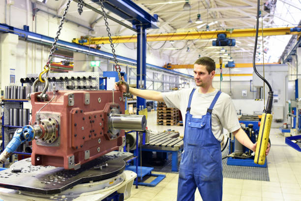 istock modern mechanical engineering - gear manufacturing factory - assembly by young workers 1346170559