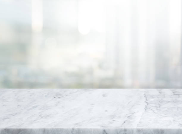 istock Selective focus.Marble table top on blur abstract window glass background. 1346172288