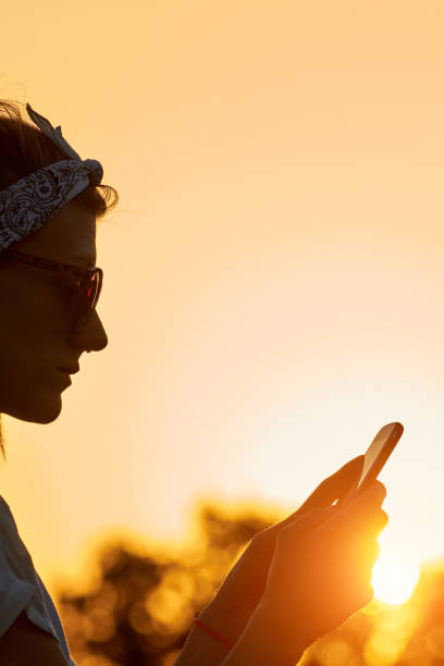 istock Female using modern smartphone outdoors. 1346172630