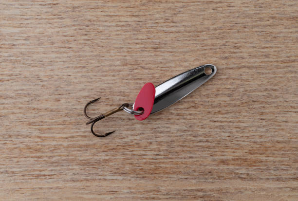 istock Simple spoon type fishing lure with a treble hook. 1346177445