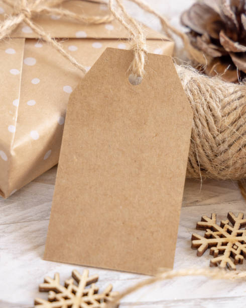 istock Christmas Gift Box with blank gift tag closeup, Mockup 1346178146