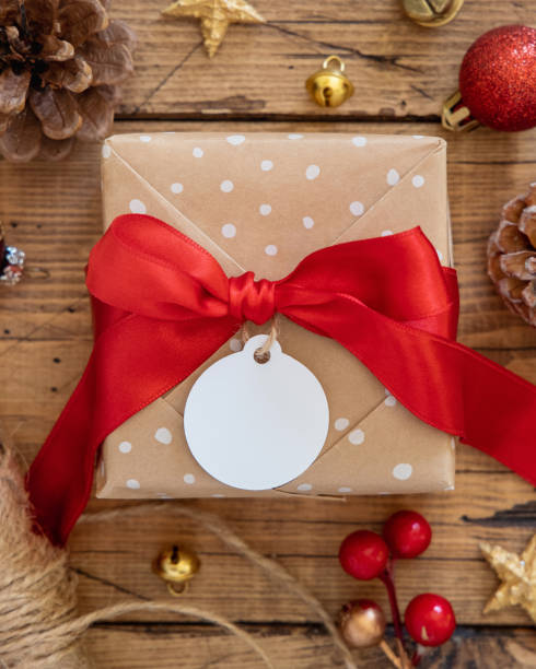 istock Christmas Gift Box with round blank gift tag top view 1346178147