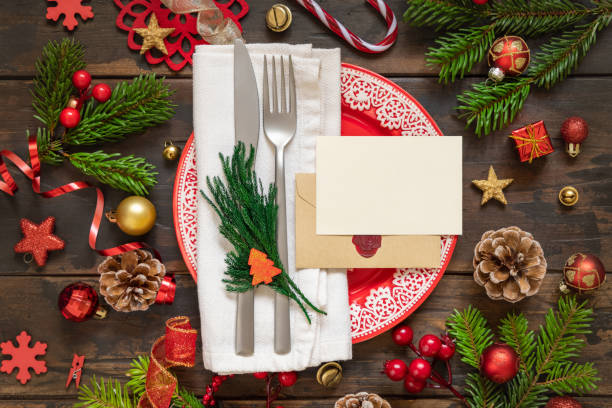 istock Festive table setting with Christmas decorations. Card and envelope mockup 1346178187