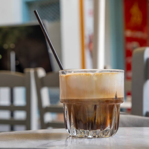 istock Side view at a foamy cold cappuccino in glass with pipette 1346180698