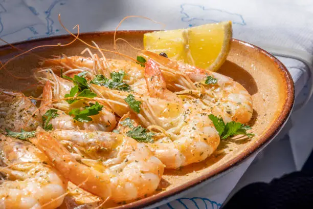 Greek food culture concept: Gourmet foodie trip to Greece as travel destination. Perfectly served fine dining plates in a taverns. A variety of delicious and fresh seafood.