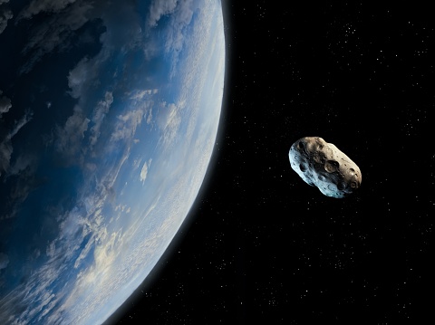 El asteroide se acerca a un planeta azul. photo