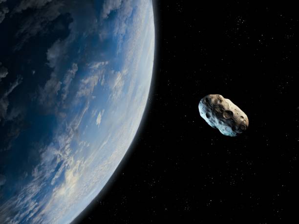 Asteroid is approaching a blue planet. stock photo