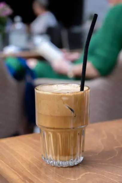 Artisanal coffee shop concept: On a service table of a street artisan Cafeteria. Typical Greek frappe drink background with copy space. Cold refreshment on hot summer days. Service occupation. Selective focus.