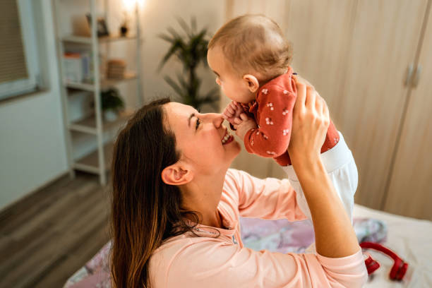 istock Mother holding her baby 1346182137