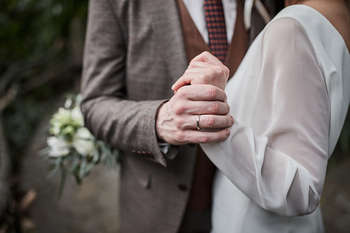 newlyweds hold hands after the wedding