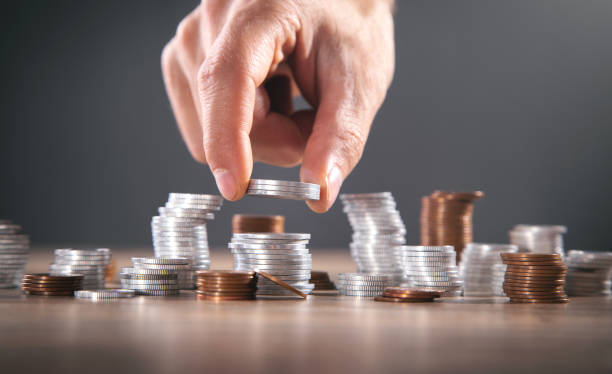 istock Male hand stacking coins. Saving money 1346185801