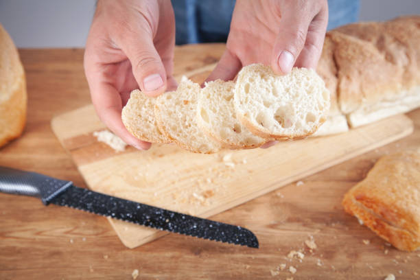 istock Caucasian man cutting bread. Healthy food 1346185807