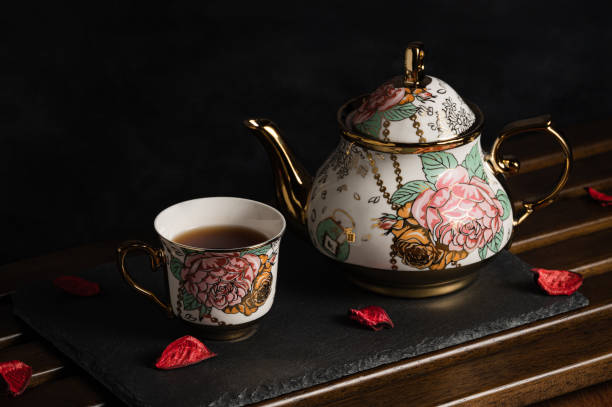 afternoon tea image with black tea and beautiful teapot and cup on board - brownie tea afternoon tea scone imagens e fotografias de stock
