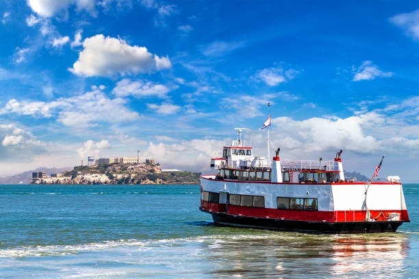 Ferry ship against Alcatraz prison Island in San Francisco, California, USA