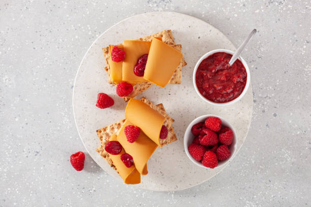 istock crispbread with Norwegian brunost traditional brown cheese and raspberry jam 1346188473