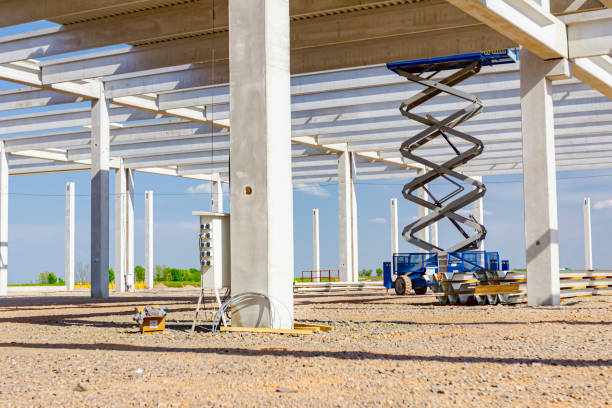 istock Mobile scaffold, stretched scissor lift platform at construction site 1346190524