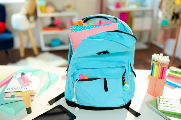 istock Closeup on white desk at student room in sunny day 1346192383