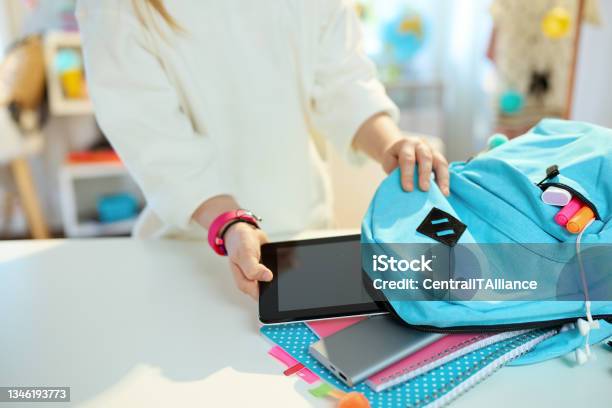 Modern School Girl Packing For School At Home In Sunny Day Stock Photo - Download Image Now