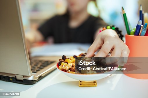 istock Modern school girl distance learning and eating healthy snack 1346194218