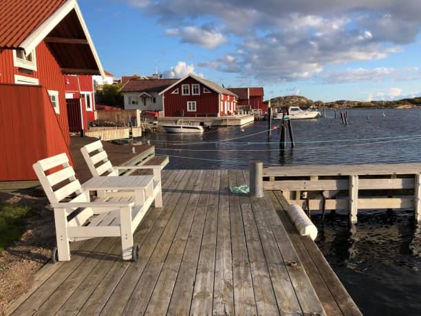традиционные красные лодочные домики в порту ховенесет, небольшой рыбацкой деревушке на архипелаге на западном побережье бохуслена, швеци - fishing village idyllic red cottage стоковые фото и изображения