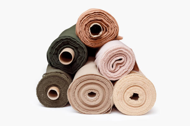 istock Stack of pastel color fabric rolls isolated on white, Synthetic and natural fabrics with copyspace 1346195244