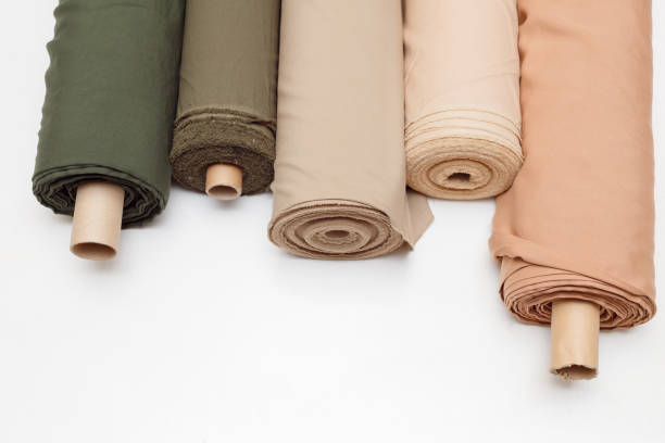 pastel color fabric rolls isolated on white, Synthetic and natural fabrics with copyspace.